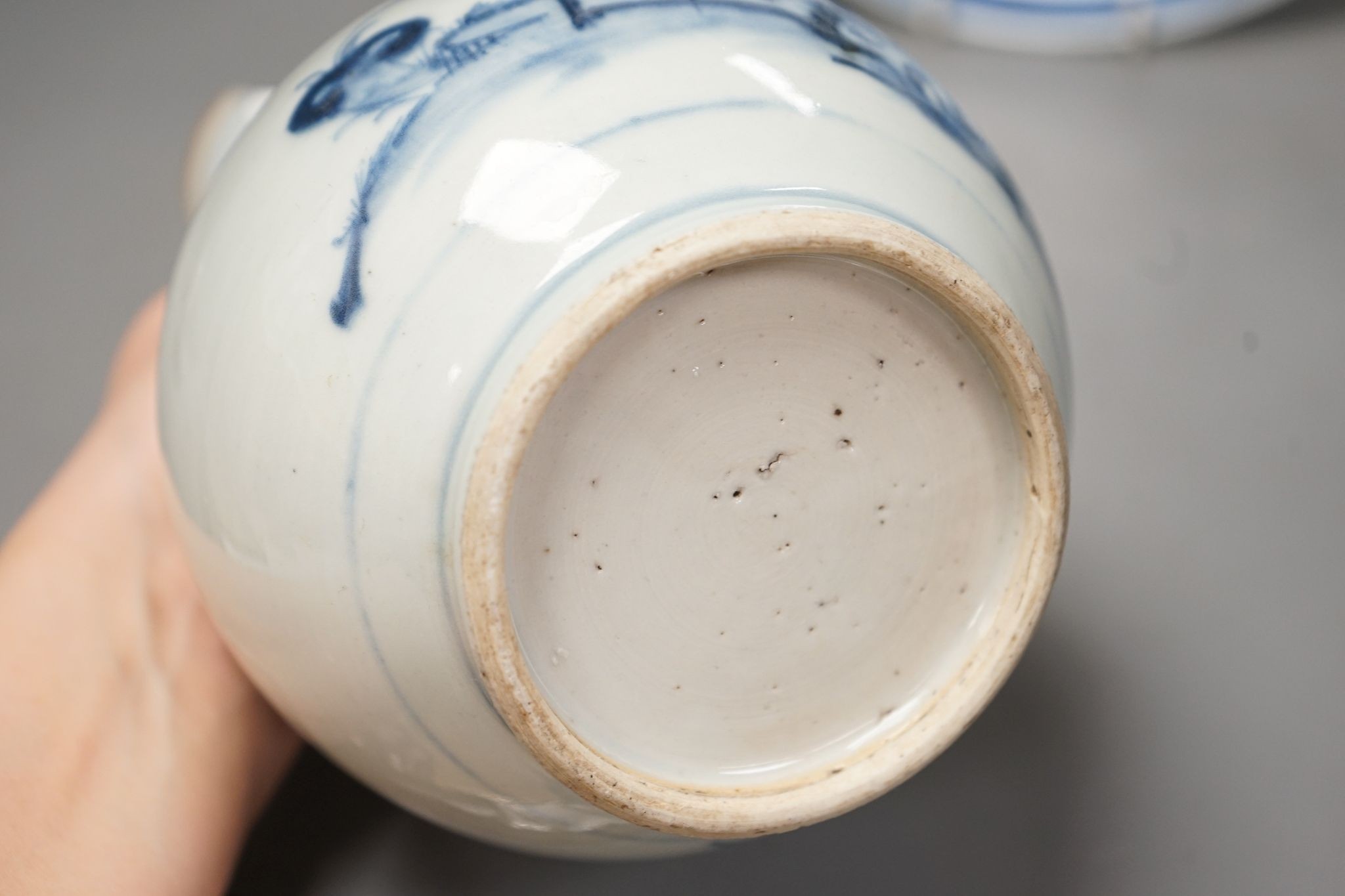 An 18th century Chinese blue and white bottle vase and two 19th century blue and white plates, diameter of largest plate - 25cm